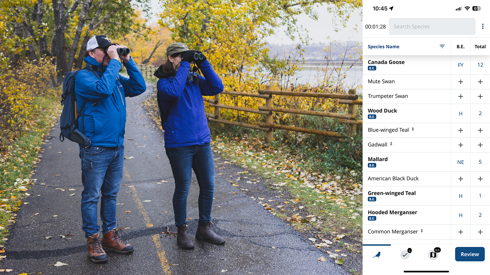 Two birdwatchers stand on a trail, looking into the distance through binoculars, alongside a screenshot of the app showing a checklist survey.